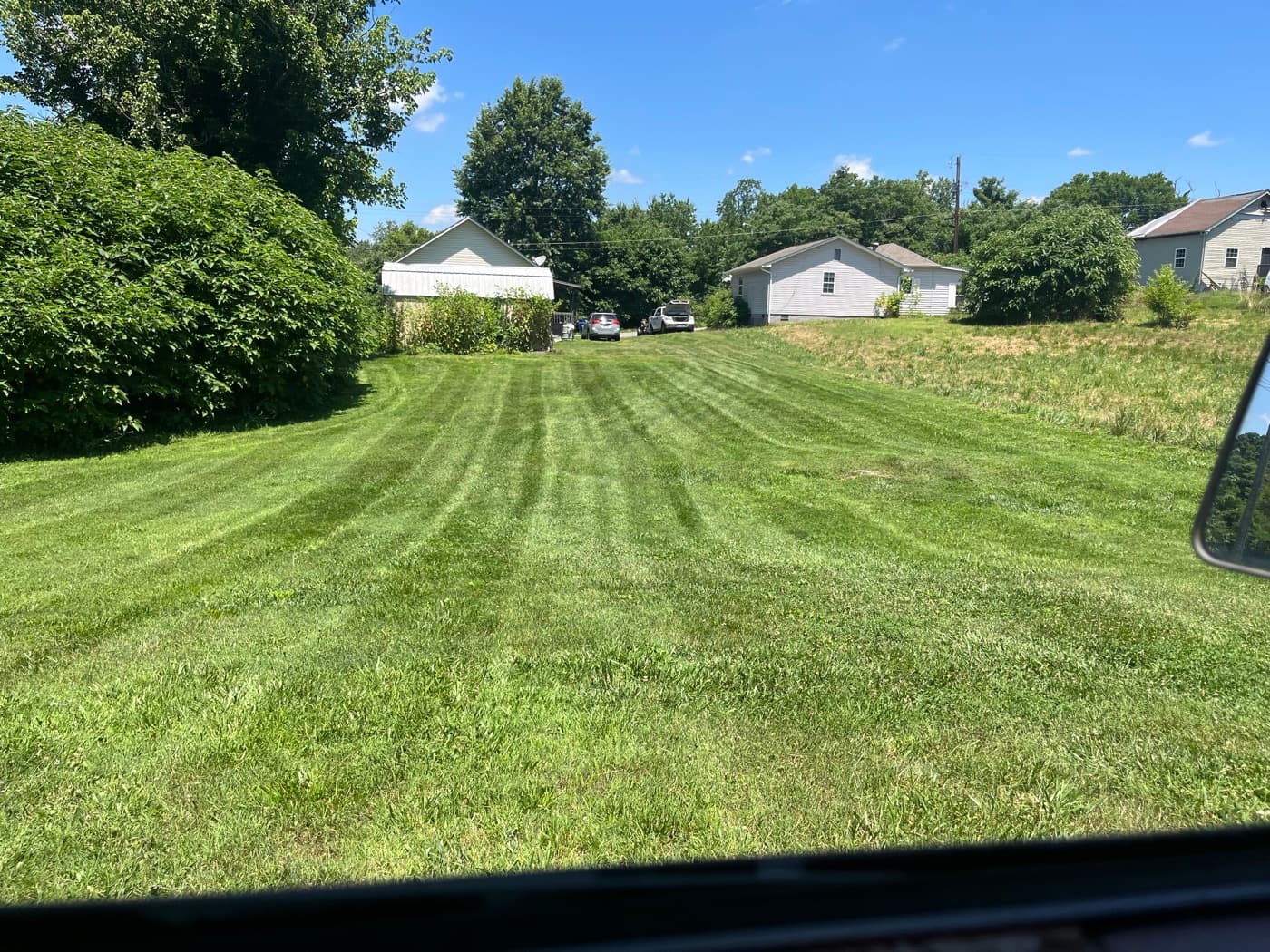 Large yard freshly mowed edge to edge with crisp mow stripes