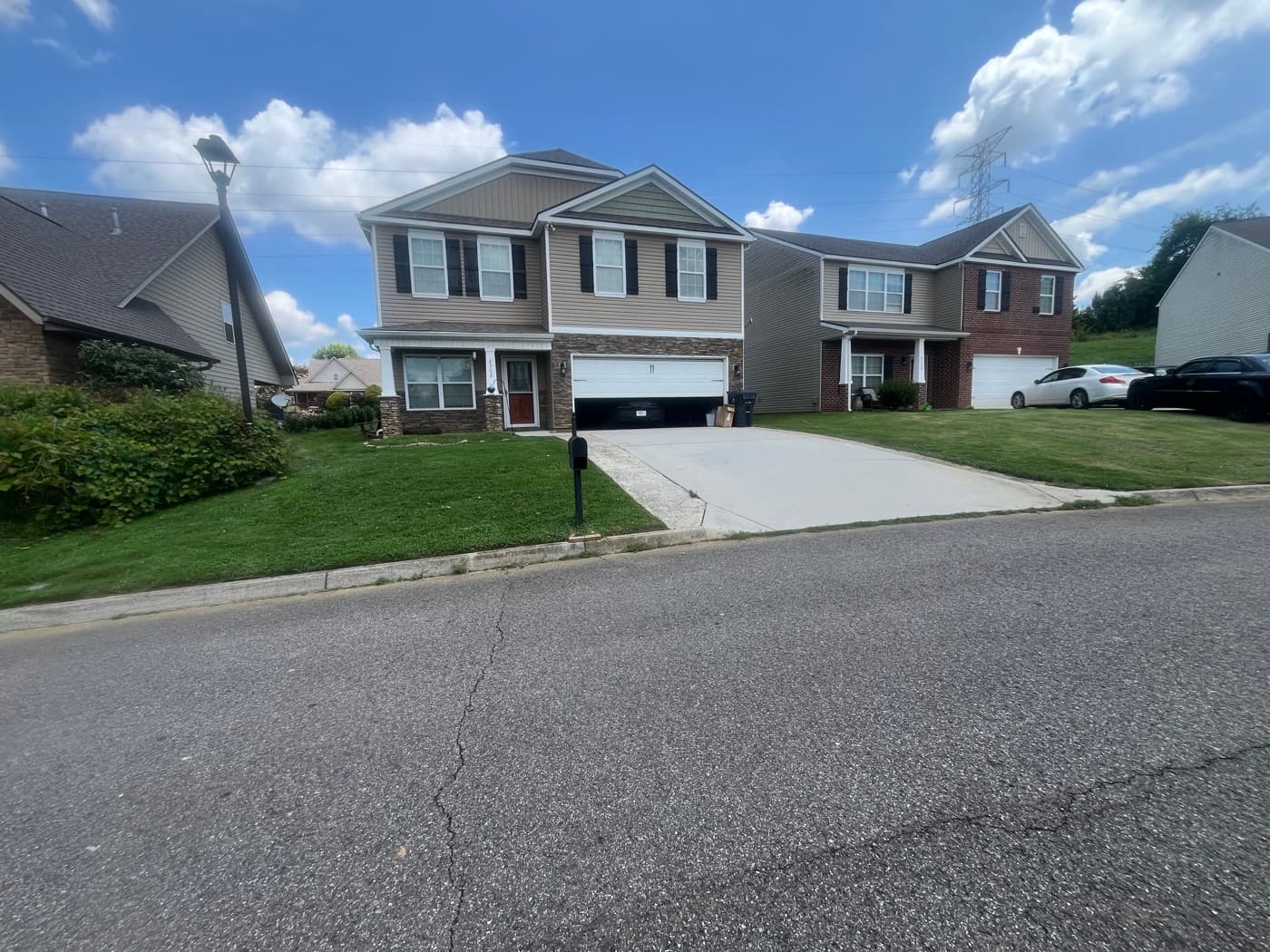 Freshly mowed and edged front lawn with clean lines along the driveway and curb